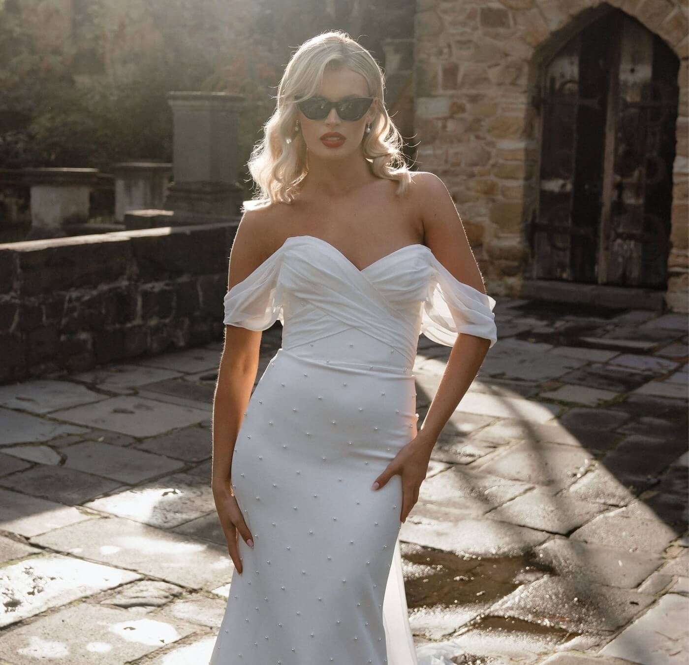 Model wearing a white gown at the street